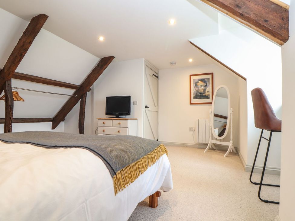 A bedroom with a bed and a TV at Ty Bryn in Marazion