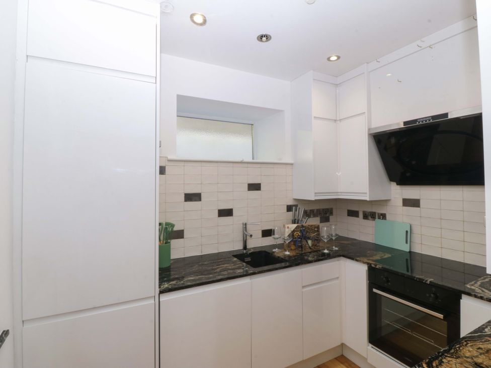 A kitchen with cabinets, sink, and oven at Apartment 1, Bryn Mel Manor Menai Bridge