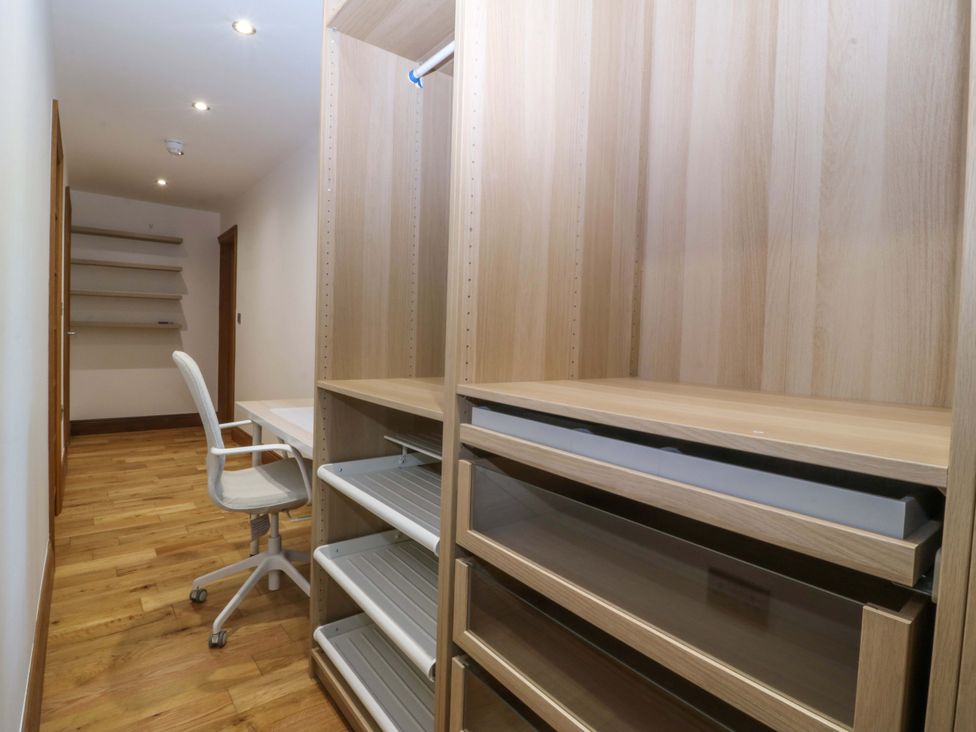 An office with a desk and shelves at Apartment 1, Bryn Mel Manor in Menai Bridge