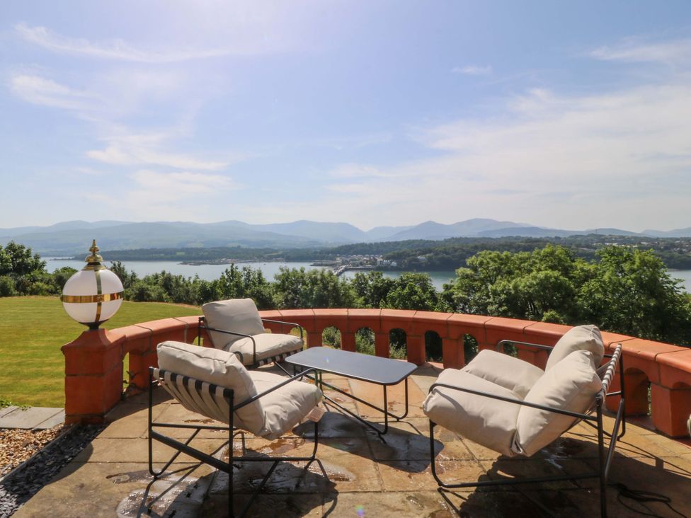 A garden with outdoor seating and a table at Apartment 1, Bryn Mel Manor in Menai Bridge