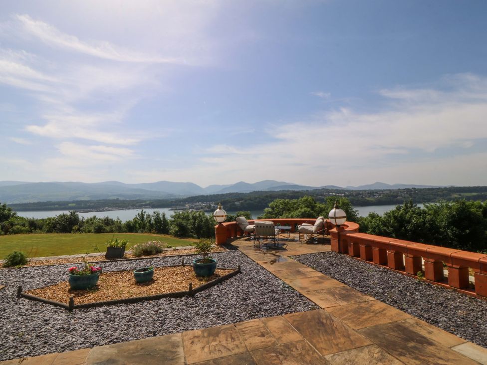 An outdoor patio with views of mountains and water at Apartment 1, Bryn Mel Manor Menai Bridge