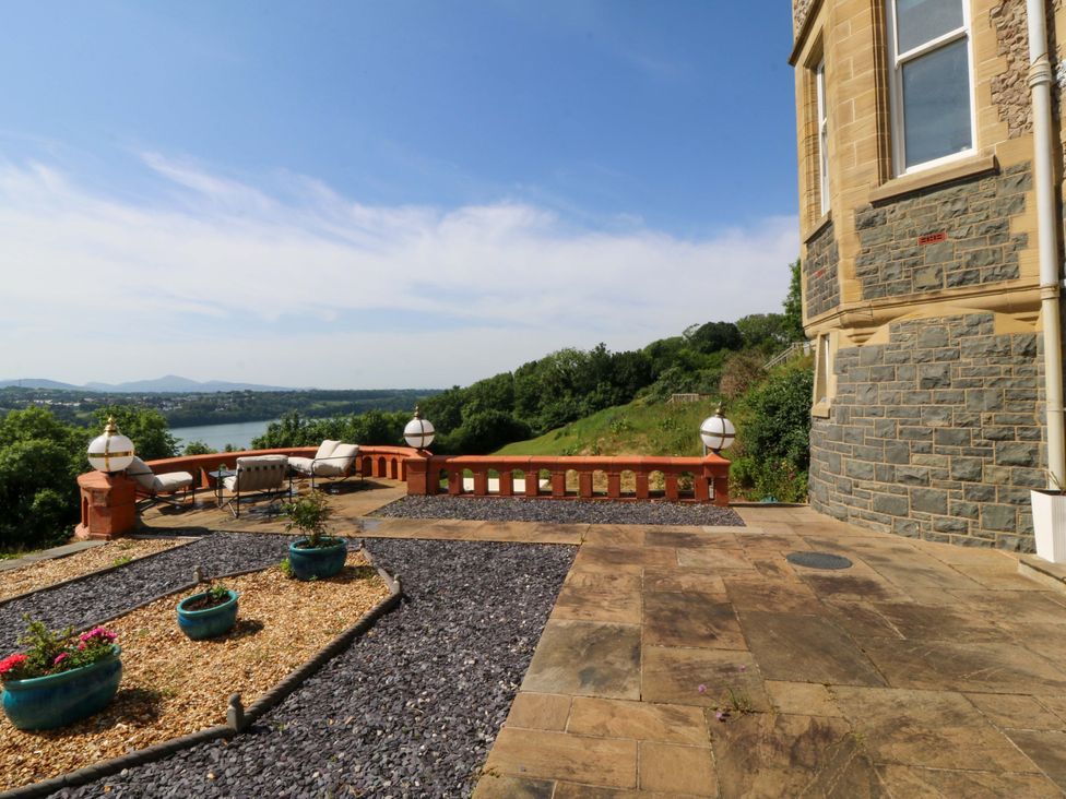 An outdoor patio area with plants and furniture at Apartment 1, Bryn Mel Manor in Menai Bridge