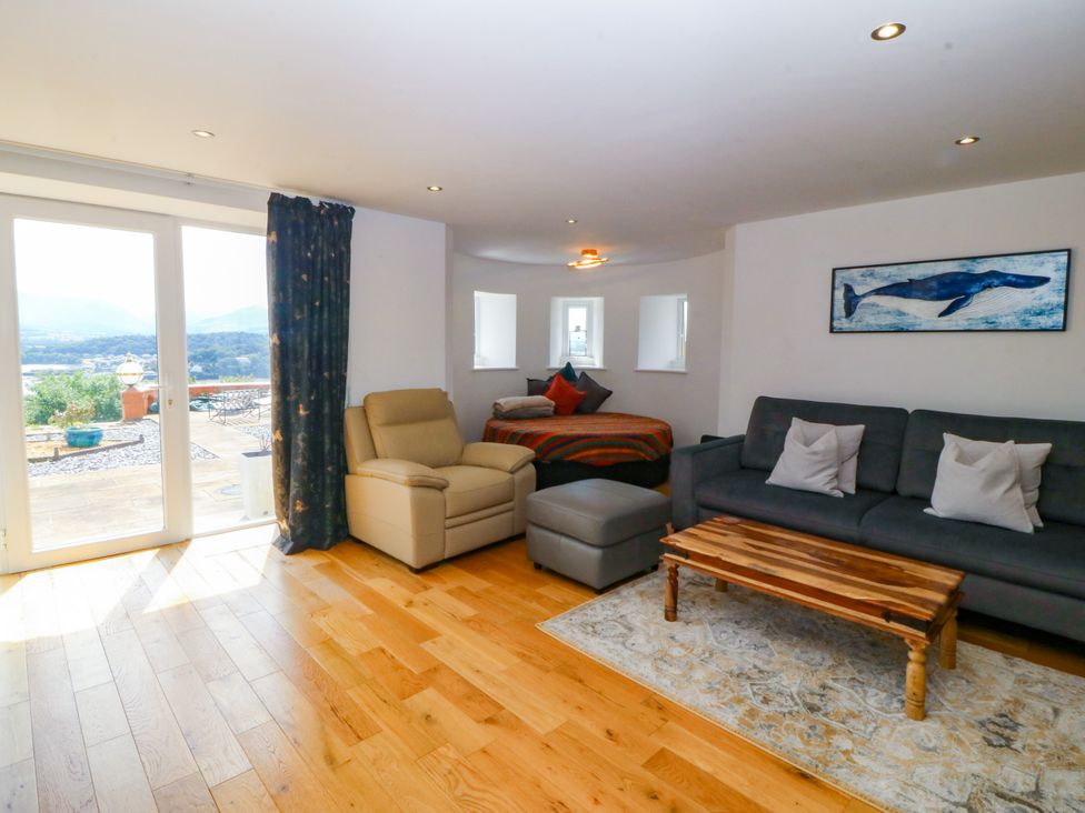 A living room with a sofa and coffee table at Apartment 1, Bryn Mel Manor Menai Bridge