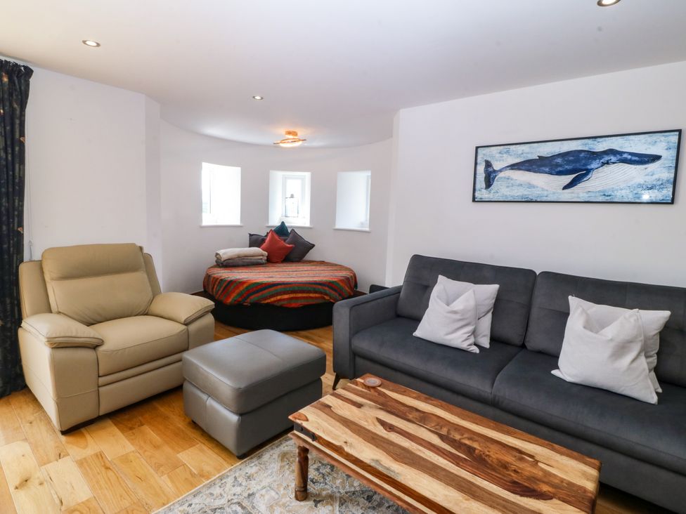 A living room with a round bed and sofa at Apartment 1, Bryn Mel Manor Menai Bridge