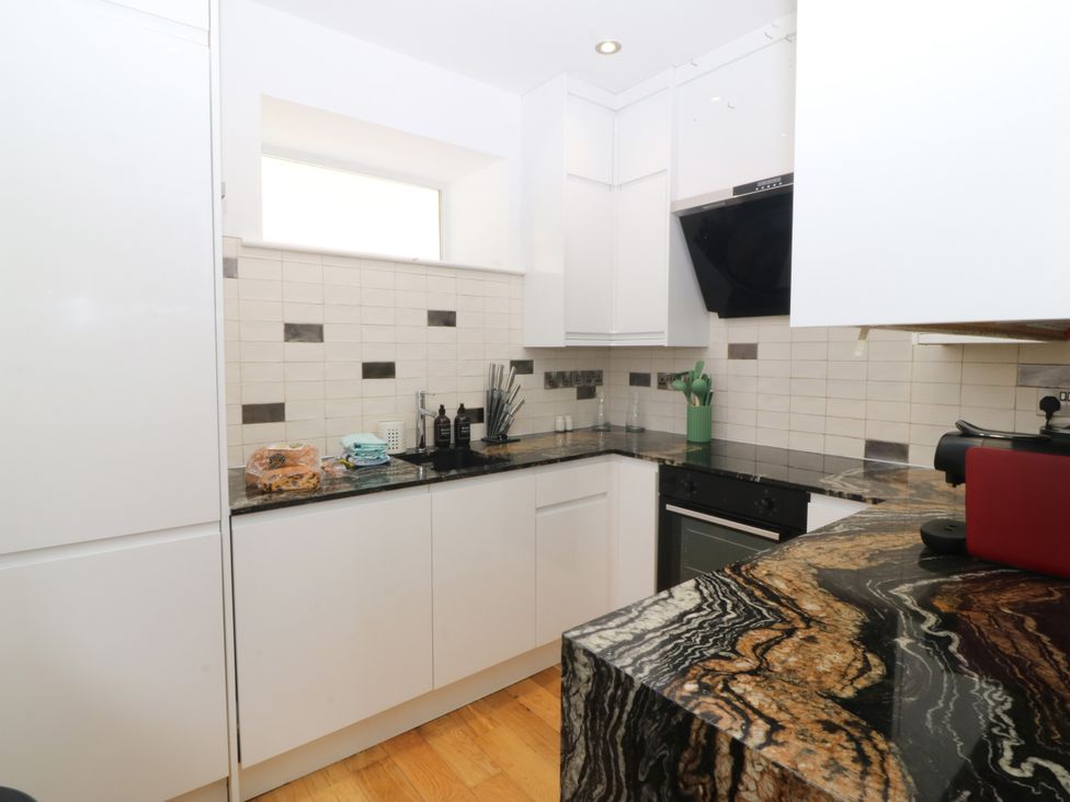 A kitchen with cabinets and a countertop at Apartment 1, Bryn Mel Manor in Menai Bridge