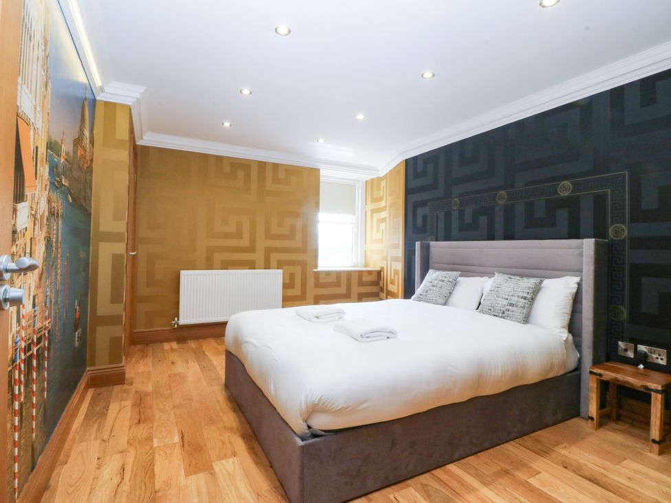A bedroom with a bed and window at Apartment 1, Bryn Mel Manor in Menai Bridge