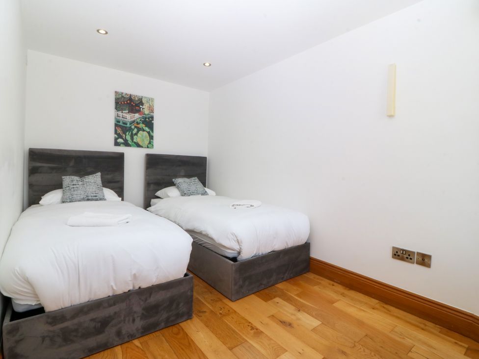 A bedroom with two single beds at Apartment 1, Bryn Mel Manor in Menai Bridge