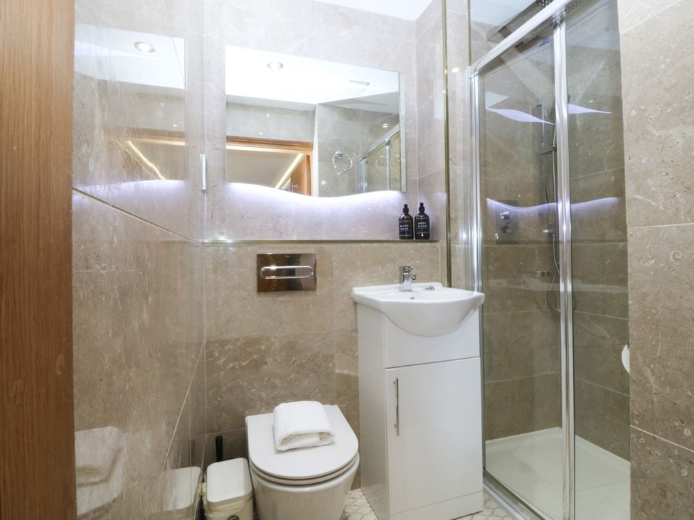 A bathroom with a shower, sink and toilet at Apartment 1, Bryn Mel Manor Menai Bridge