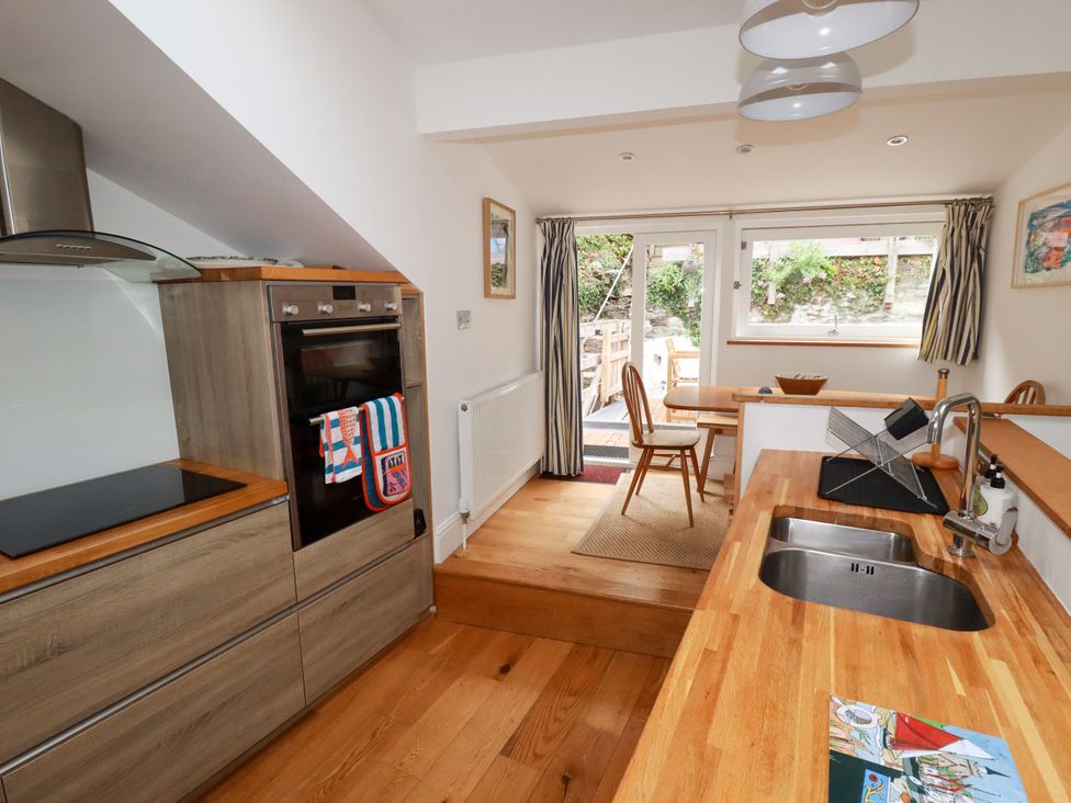 A kitchen with a sink and oven at Dolphin Cottage in Falmouth