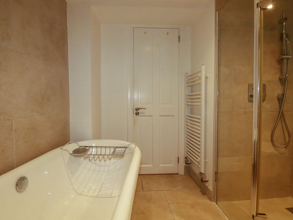 A bathroom with a bathtub and shower at Dolphin Cottage in Falmouth