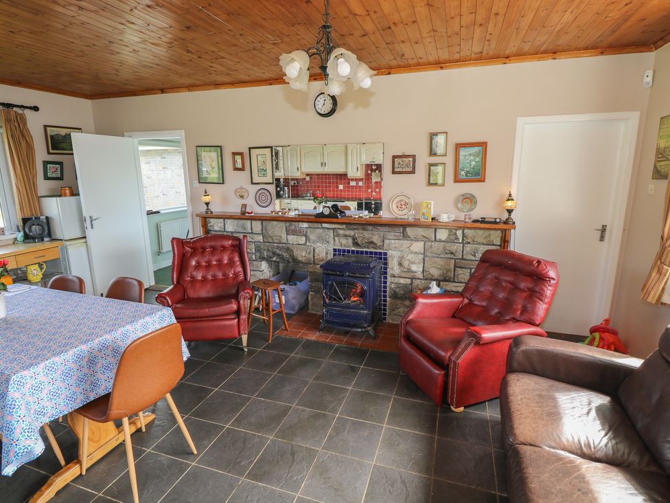 A kitchen with a dining table and chairs at Sweetbriar Lodge in Castlerea
