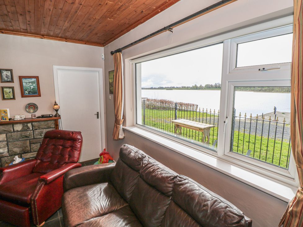 A living room with a view of the lake at Sweetbriar Lodge Castlerea
