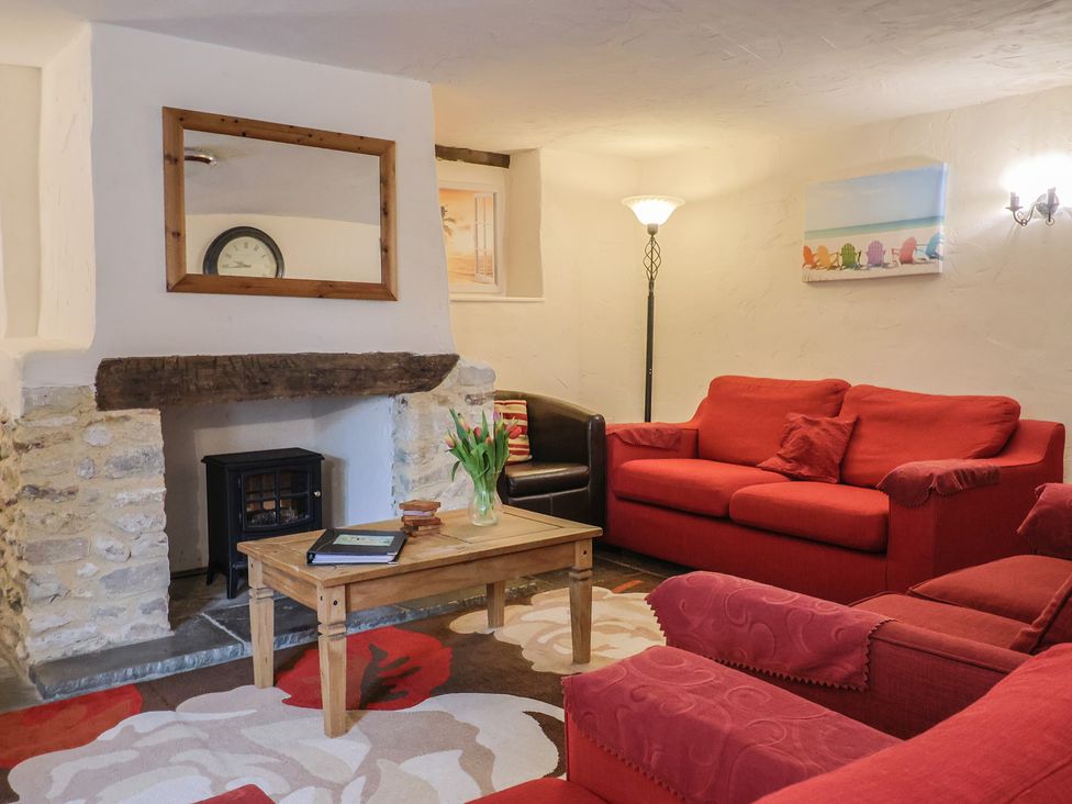 A living room with a sofa and coffee table at Cider Cottage in Hawkchurch