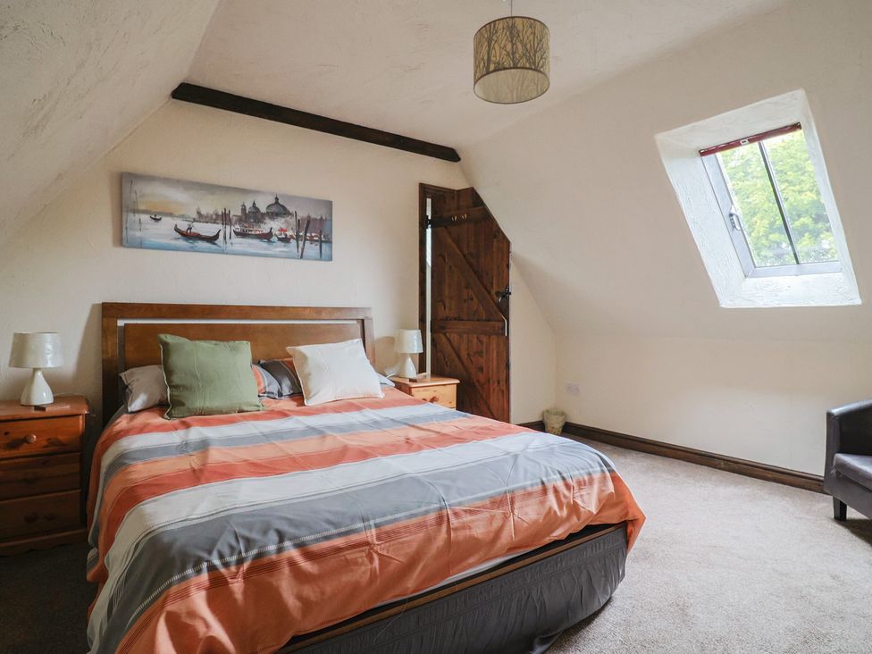A bedroom with a bed and bedside tables at Cider Cottage in Hawkchurch