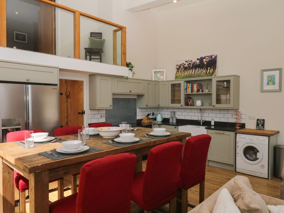 A kitchen with a dining table and chairs at Fieldstone Barn in North Tawton