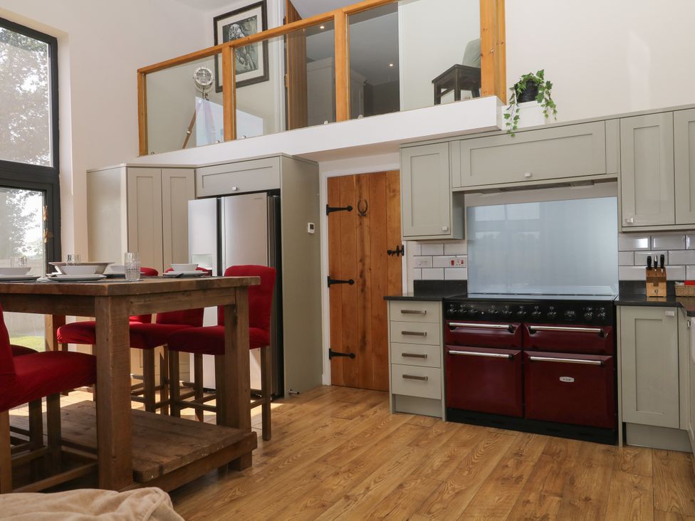 A kitchen with a table and chairs at Fieldstone Barn North Tawton