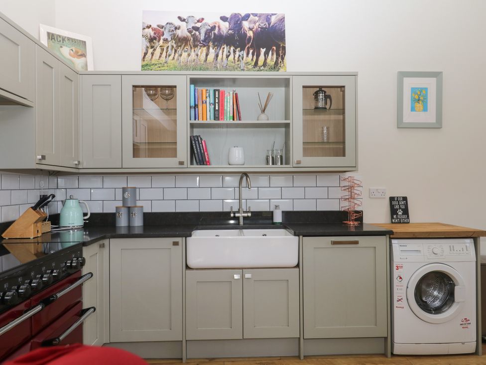 A kitchen with cabinets and a sink at Fieldstone Barn North Tawton