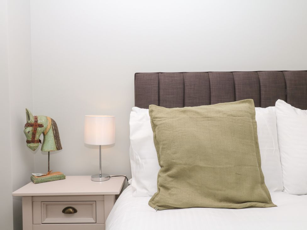 A bedroom with a bed and lamp at Fieldstone Barn North Tawton