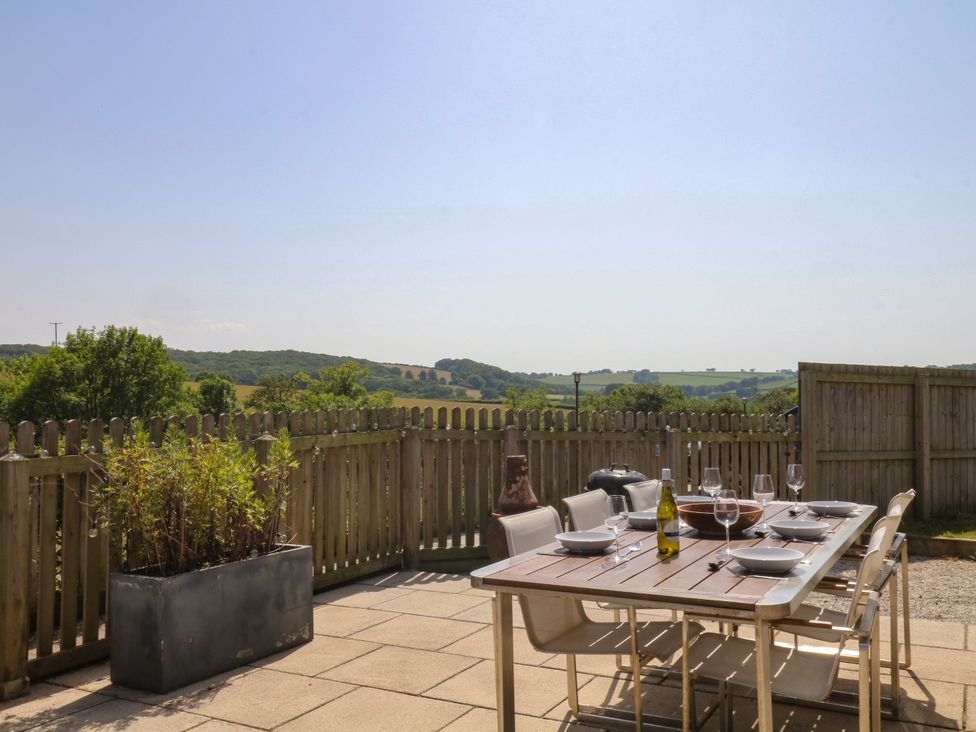 An outdoor dining area with a table set at Fieldstone Barn North Tawton