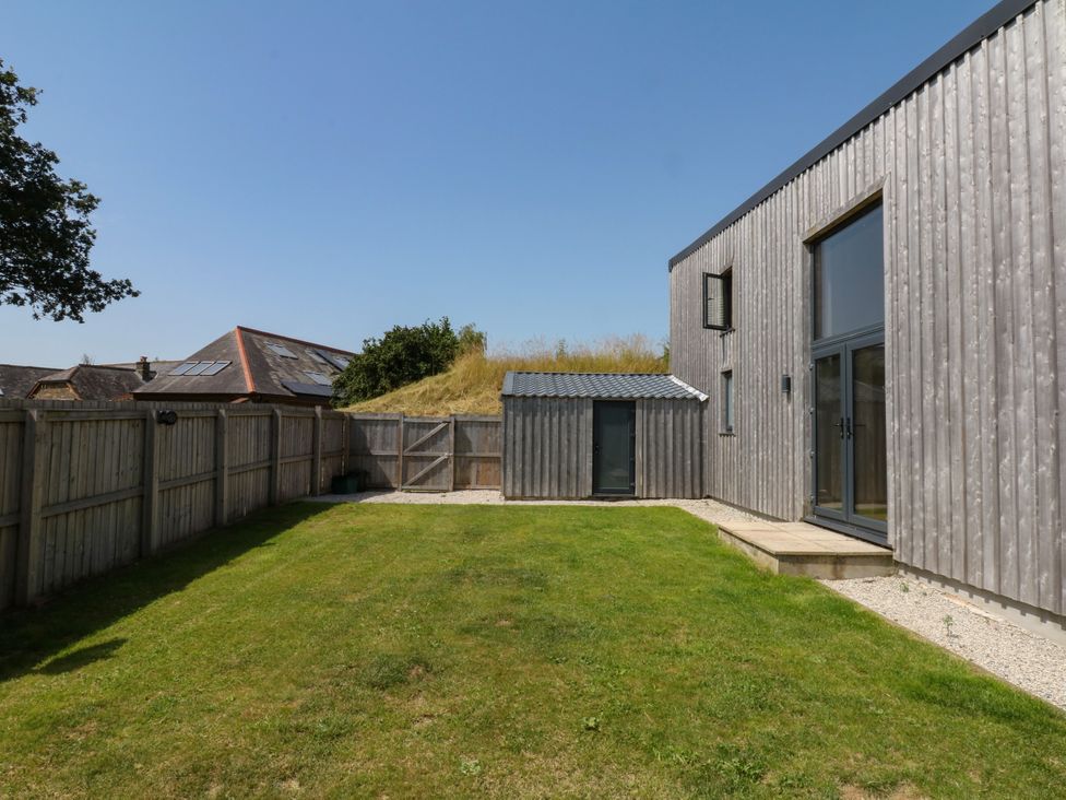 A garden with grass and a shed at Fieldstone Barn North Tawton