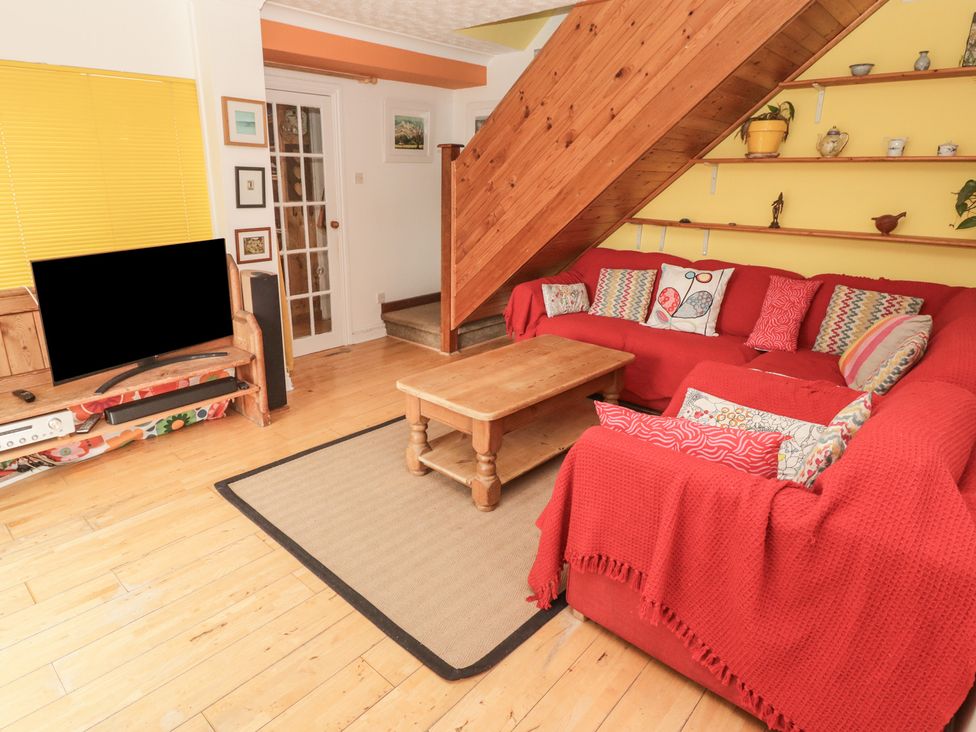 A living room with a sofa and coffee table at 1 Rosemount Garden Villas, Tenby