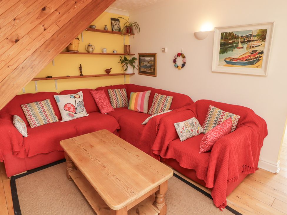 A living room with a sofa and coffee table at 1 Rosemount Garden Villas in Tenby
