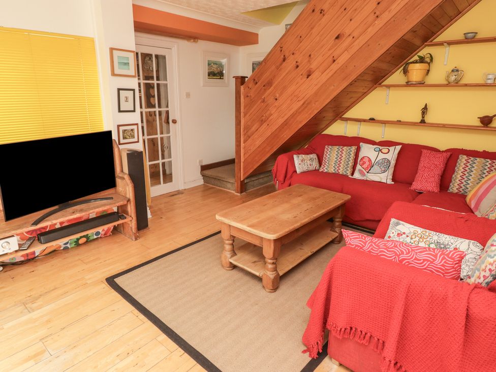 A living room with a sofa and coffee table at 1 Rosemount Garden Villas in Tenby