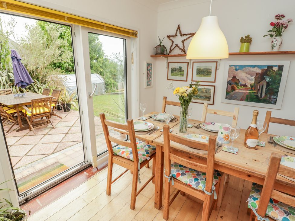 A dining room with a wooden table and chairs at 1 Rosemount Garden Villas Tenby