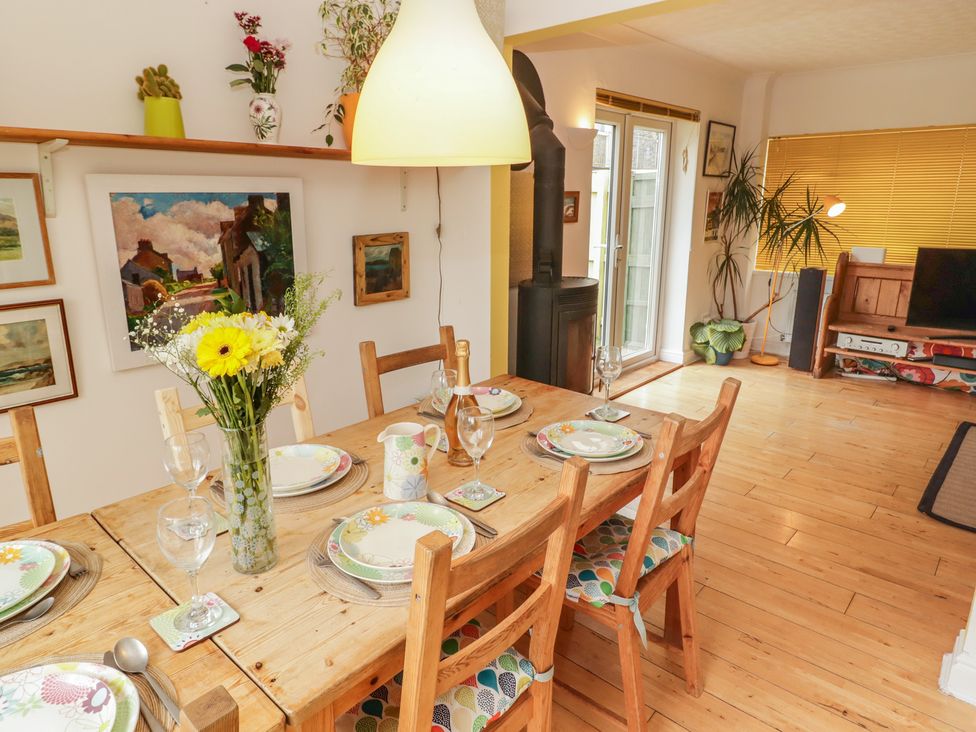 A dining room with a table set for a meal at 1 Rosemount Garden Villas Tenby