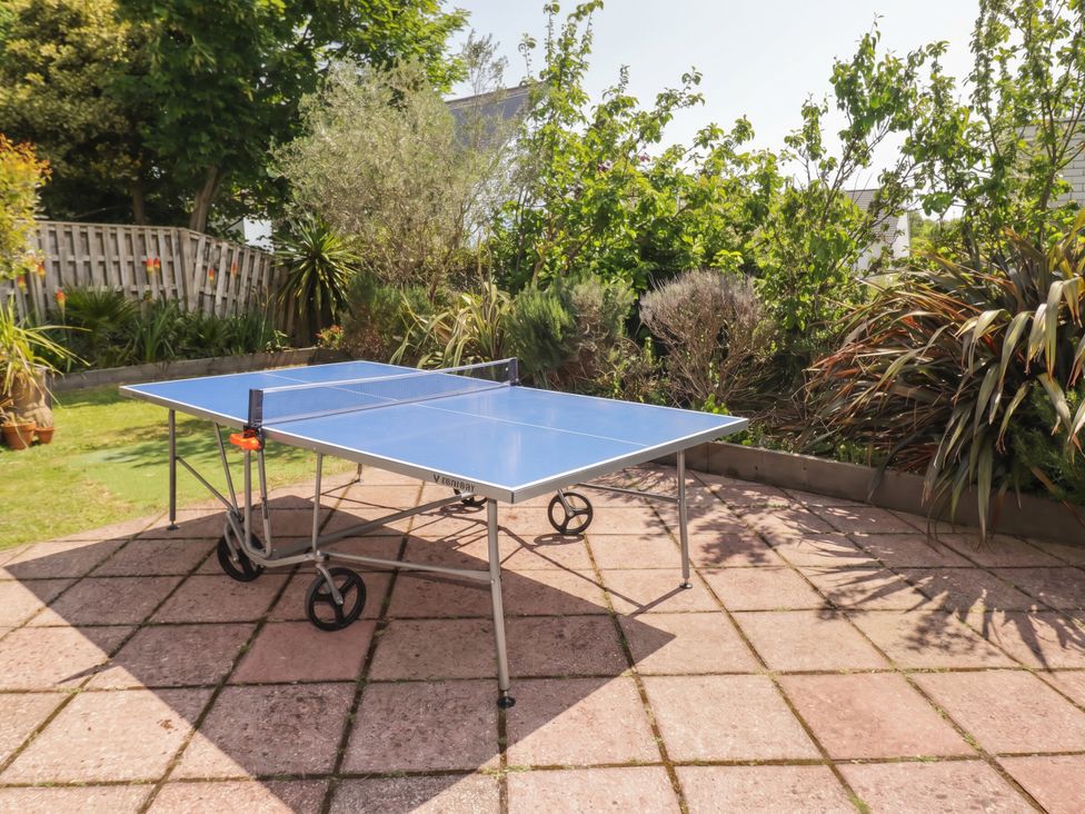 A ping pong table on a patio in the garden at 1 Rosemount Garden Villas Tenby