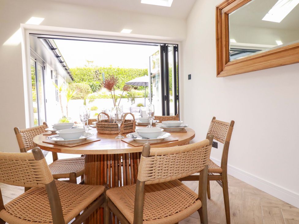 A dining room with a table set for a meal at No.45 Whealgolden Drive Newquay