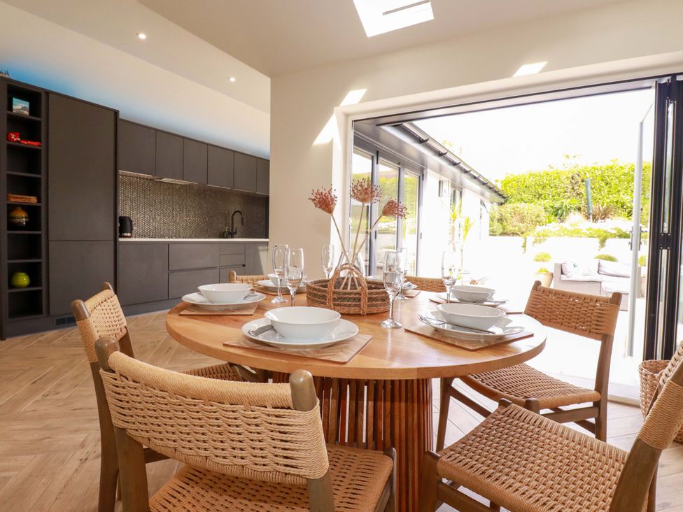 A dining room with a round table and chairs at No.45 Whealgolden Drive in Newquay