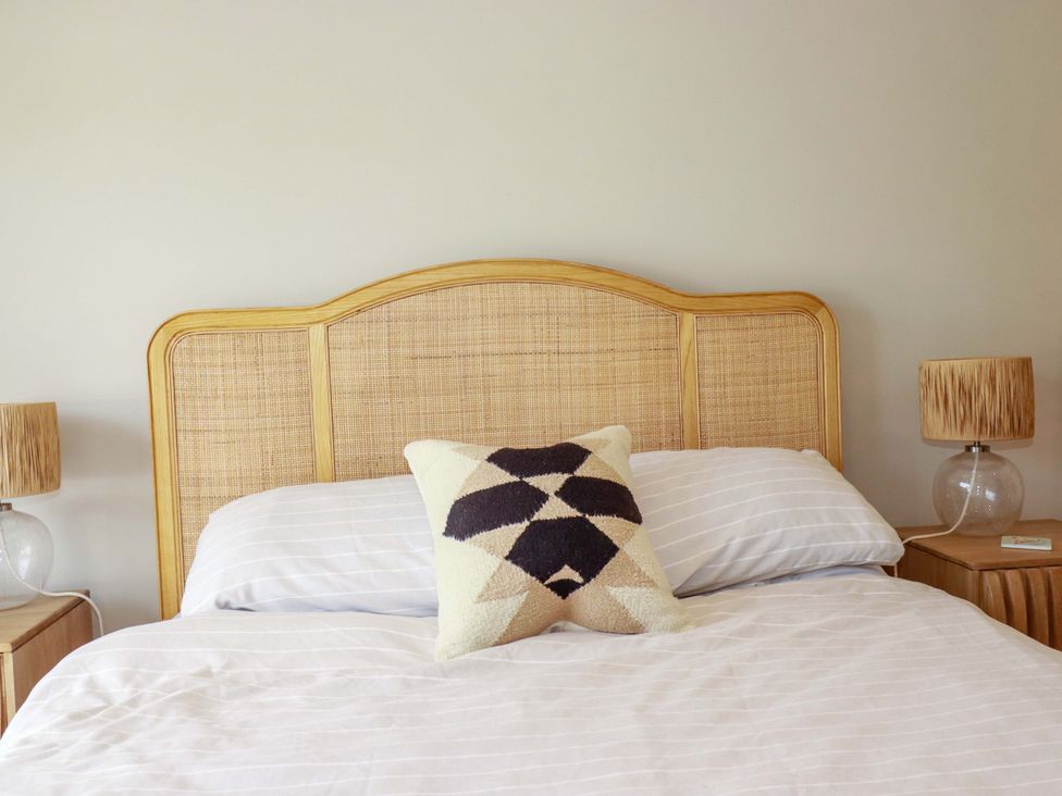A bedroom with a bed and pillows at No.45 Whealgolden Drive in Newquay