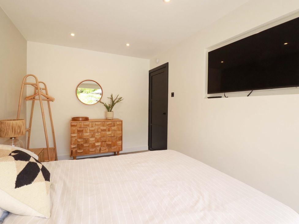 A bedroom with a bed and television at No.45 Whealgolden Drive Newquay
