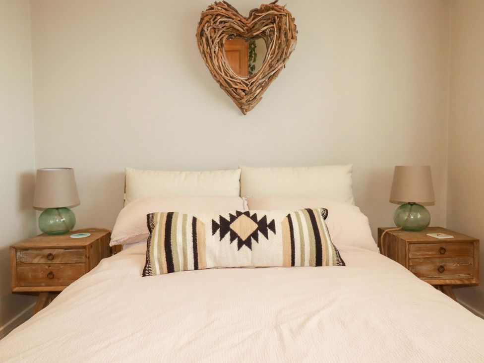 A bedroom with a bed and decorative items at No.45 Whealgolden Drive, Newquay