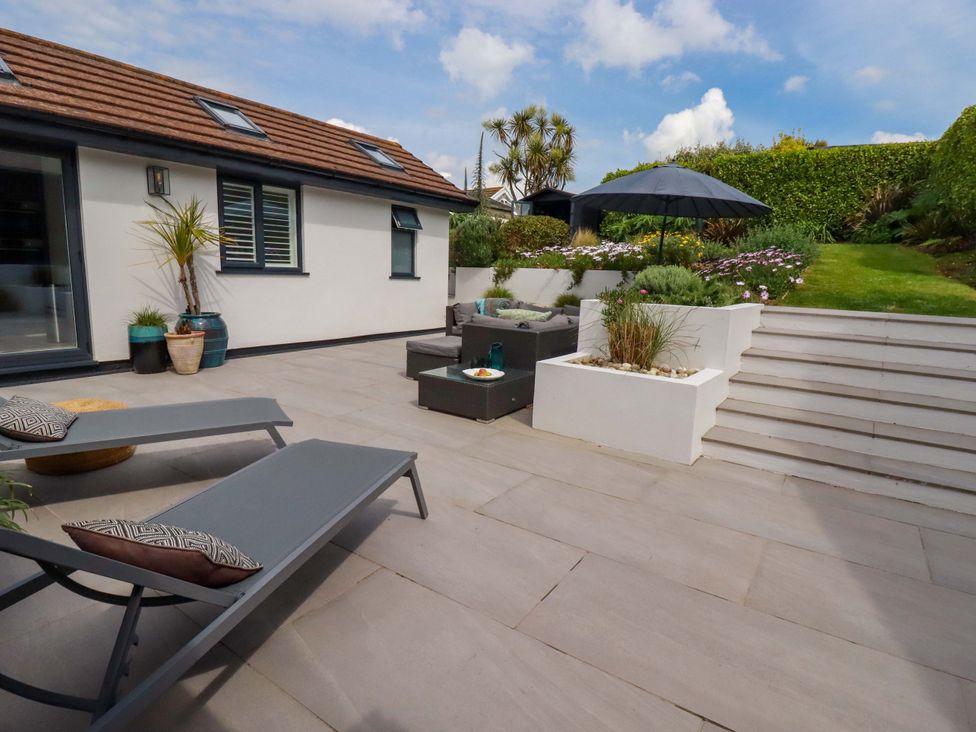 A garden with outdoor furniture and plants at No.45 Whealgolden Drive Newquay