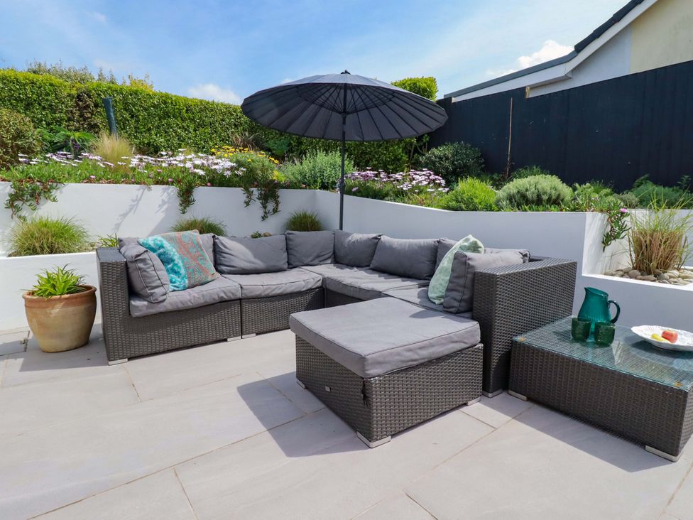 An outdoor seating area with a sofa and table at No.45 Whealgolden Drive in Newquay