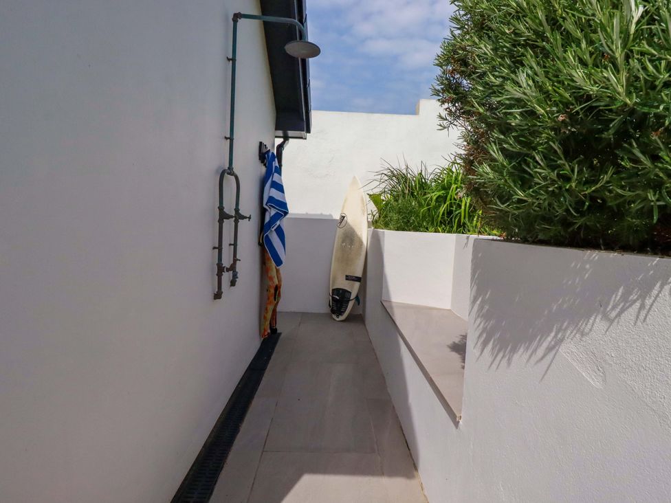 An outdoor space with a shower and surfboard at No.45 Whealgolden Drive Newquay