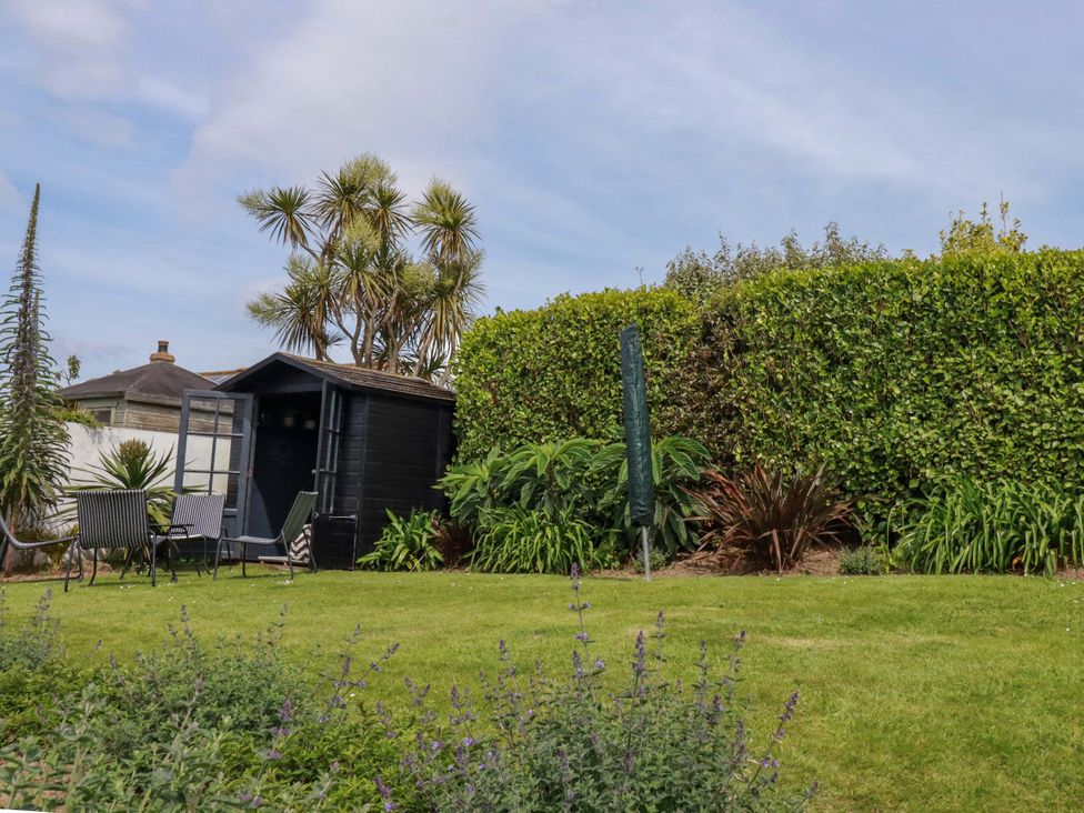 A garden with a shed and seating area at No.45 Whealgolden Drive Newquay