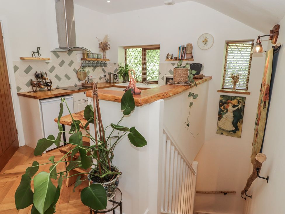 A kitchen with a counter and stove at Cân adar in Llangeinor
