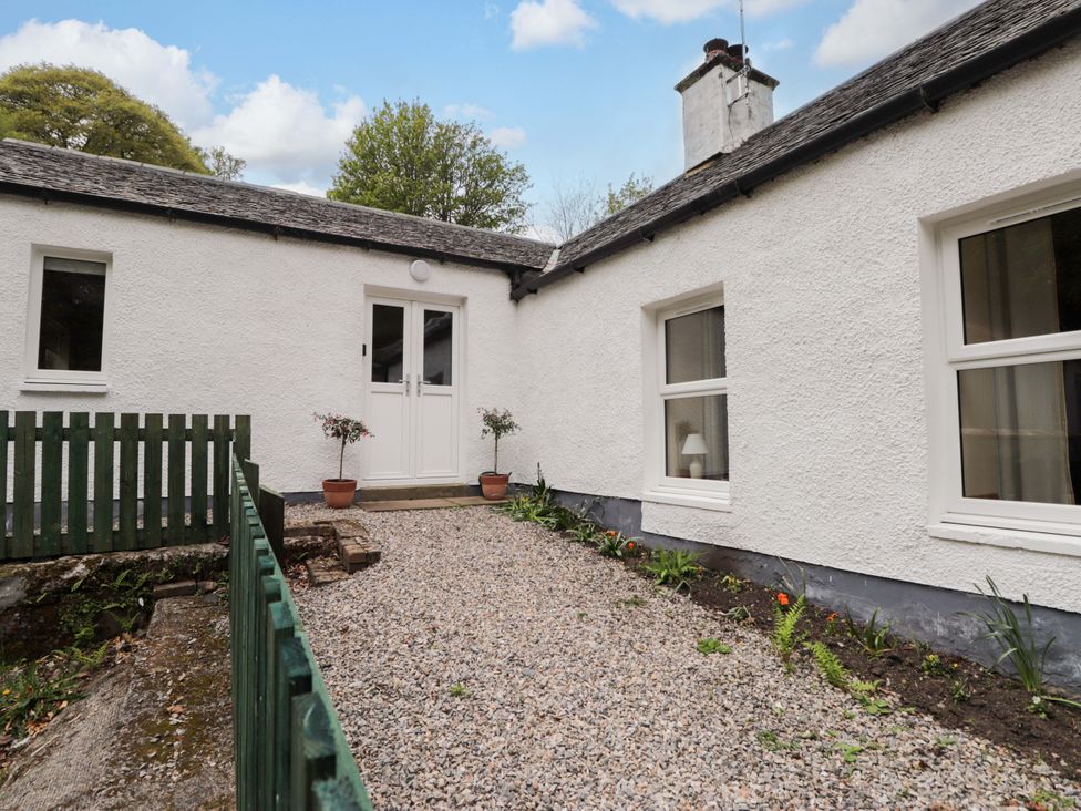 An outdoor view of a path leading to a door at Laundry Cottage in Strathpeffer