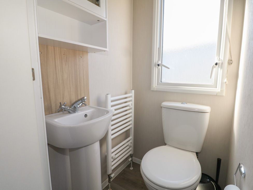 A bathroom with a sink and a toilet at Seaside Retreat Selsey