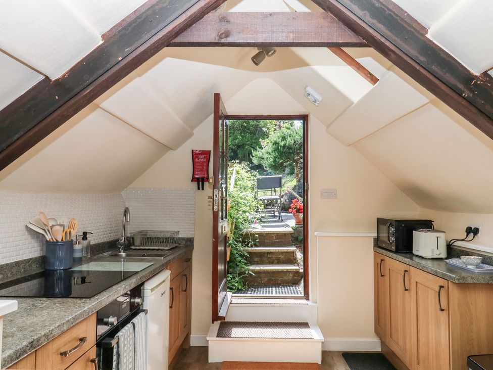 A kitchen with a door leading to a garden at The Mill Barn in Lustleigh