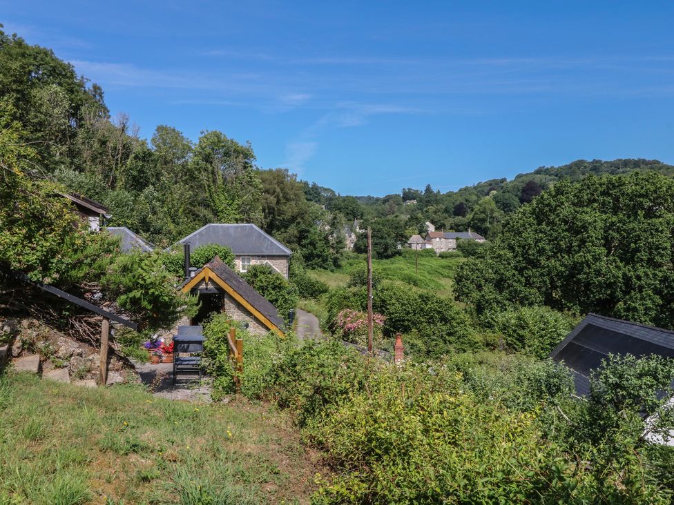 A view of houses and greenery at The Mill Barn in Lustleigh