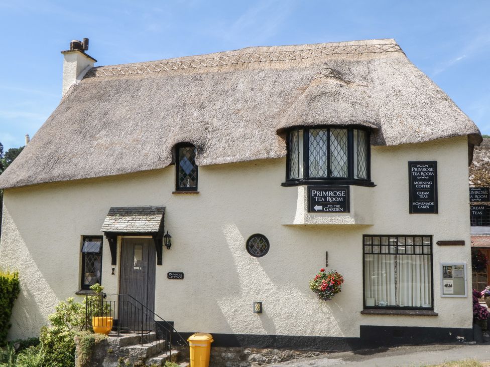 A exterior of a tea room with a thatched roof at The Mill Barn in Lustleigh