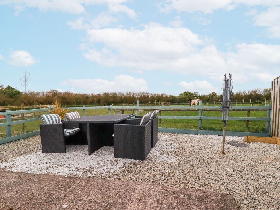 An outdoor seating area with a table and chairs at Moorland View Belowda near Roche