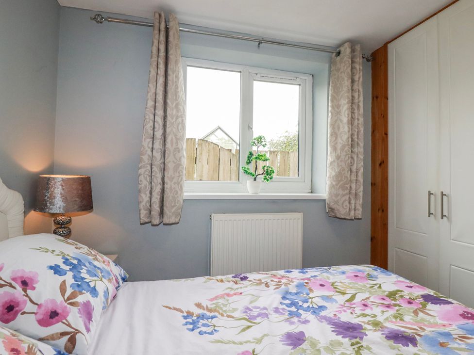 A bedroom with a bed and window at Moorland View Belowda near Roche