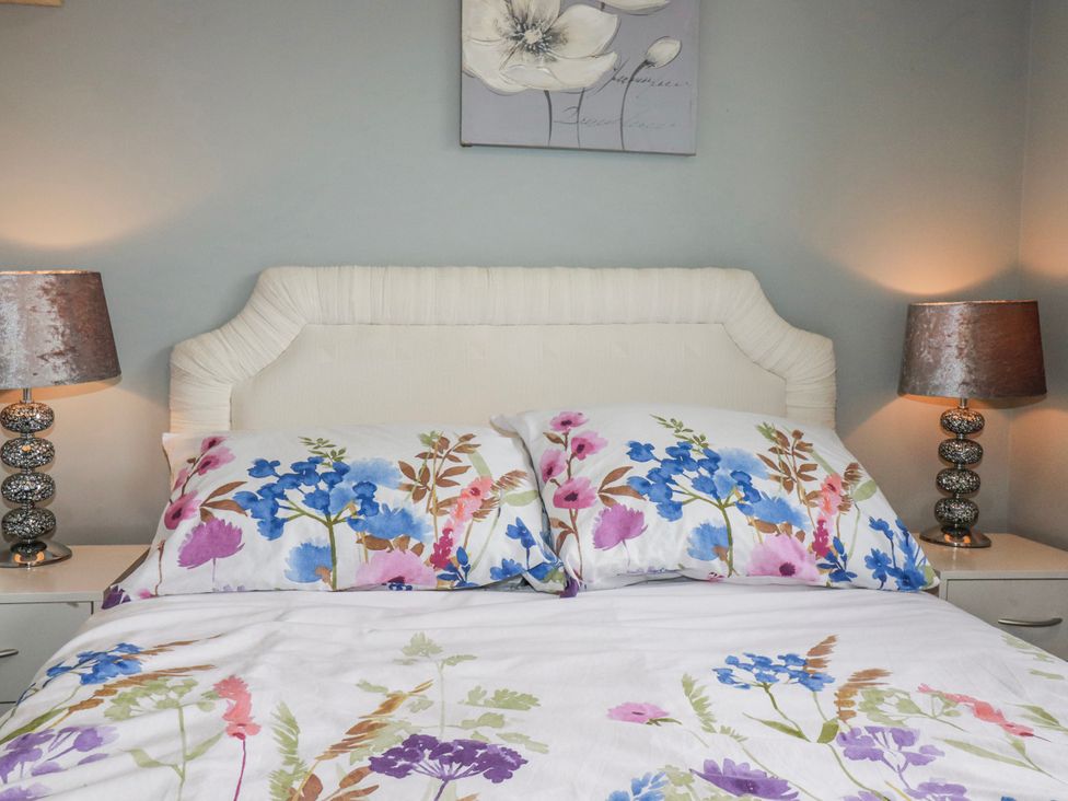 A bedroom with a bed and lamps at Moorland View Belowda near Roche