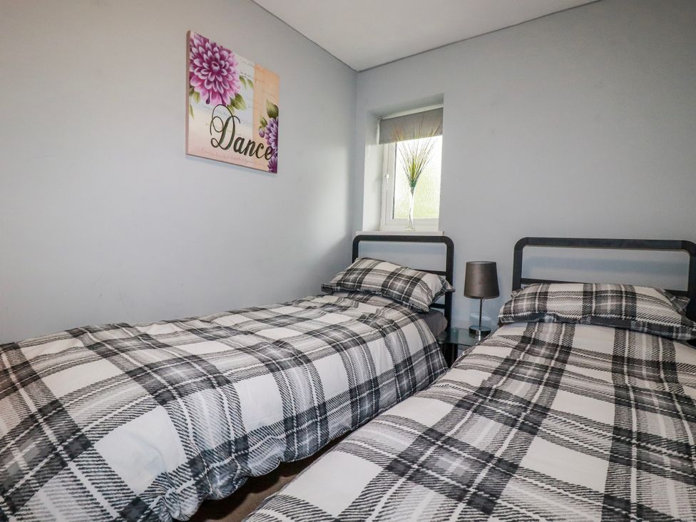 A bedroom with two beds and a window at Moorland View Belowda near Roche
