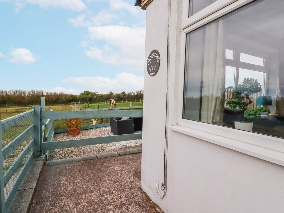 An outdoor area with a sign and fence at Moorland View Belowda near Roche
